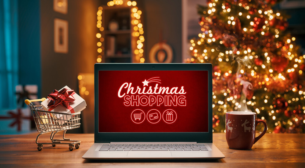 a laptop with a Christmas shopping page image on the screen